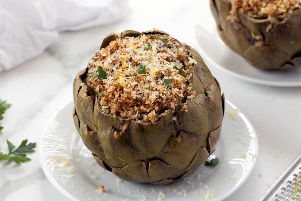 stuffed artichokes on a white plate.