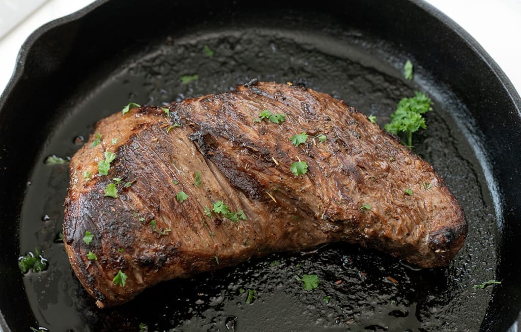 Oven baked tri tip in a cast iron skillet.