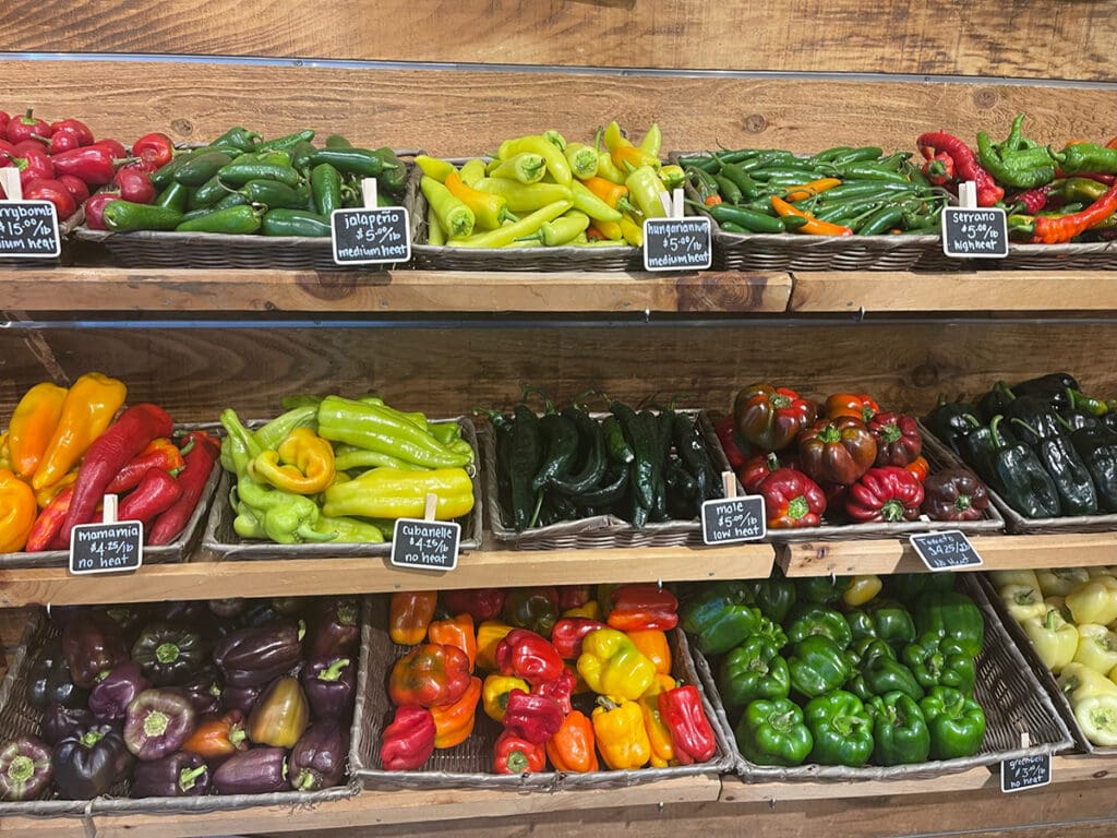 Baskets of fresh produce such as peppers and tomatoes.