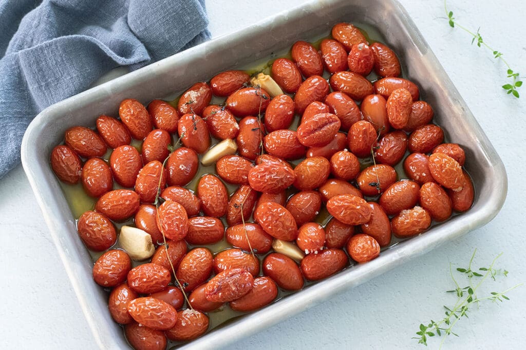 Tomato Confit on a silver baking sheet.