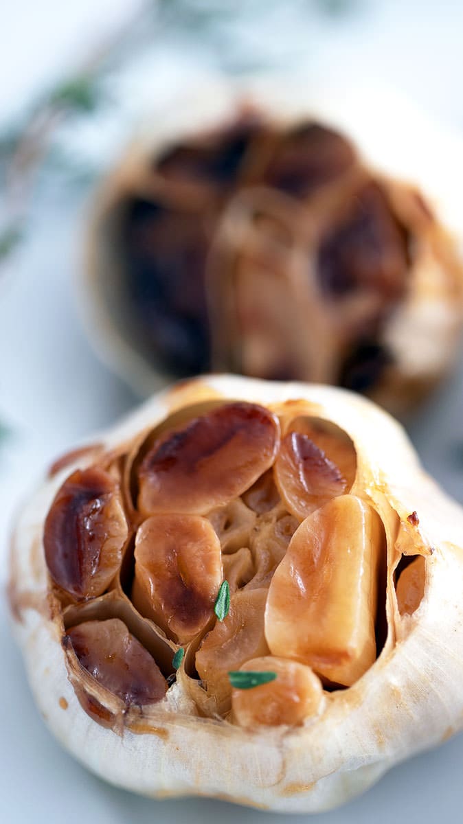 Oven Roast Garlic with a thyme leaf.