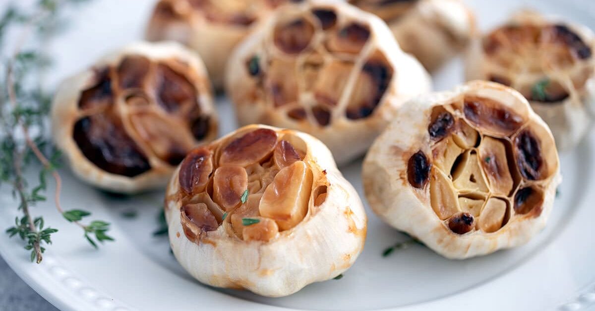 Roasted garlic on a white plate.
