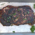 Blackstone Steak on a silver baking sheet.