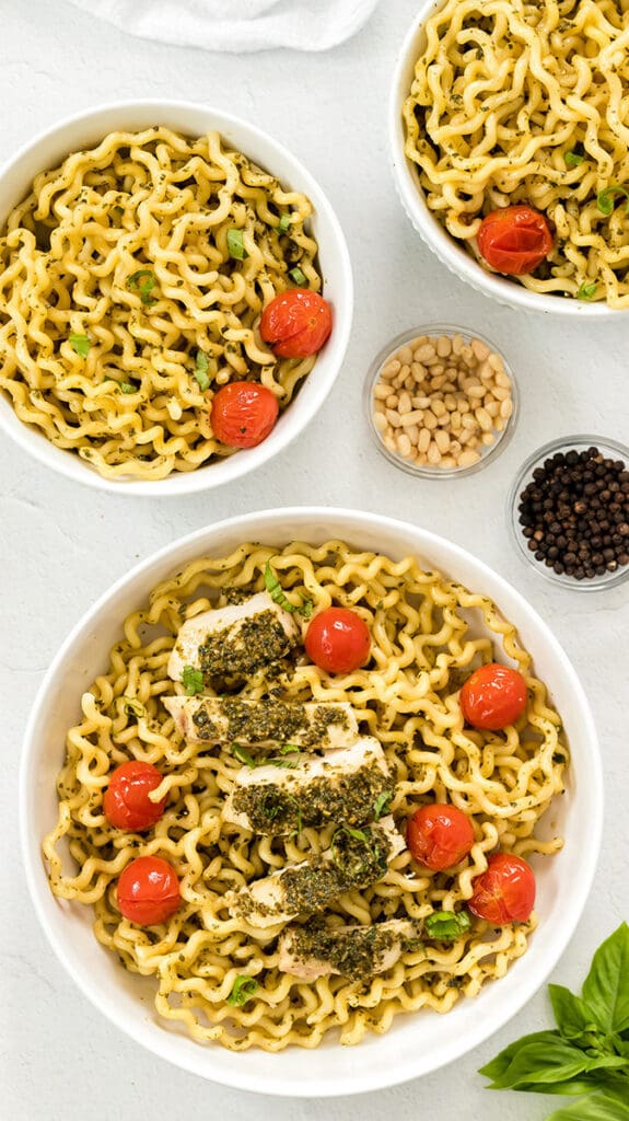 Three bowls of pasta al pesto.