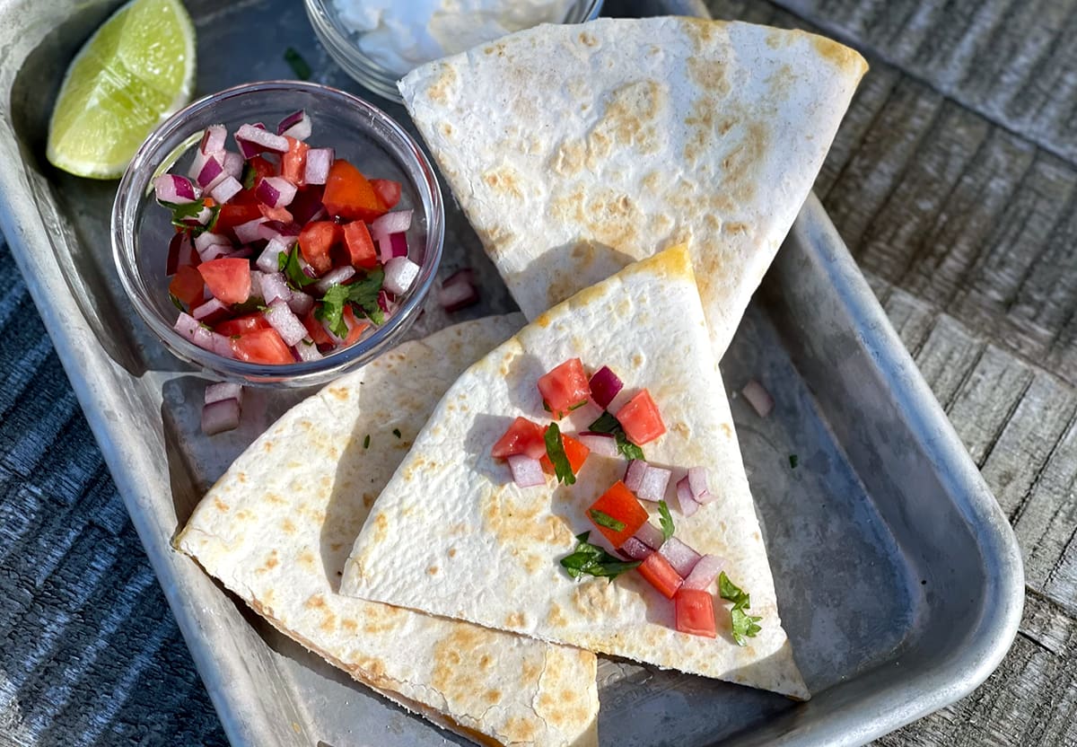 Blackstone Quesadilla topped with pico de gallo.