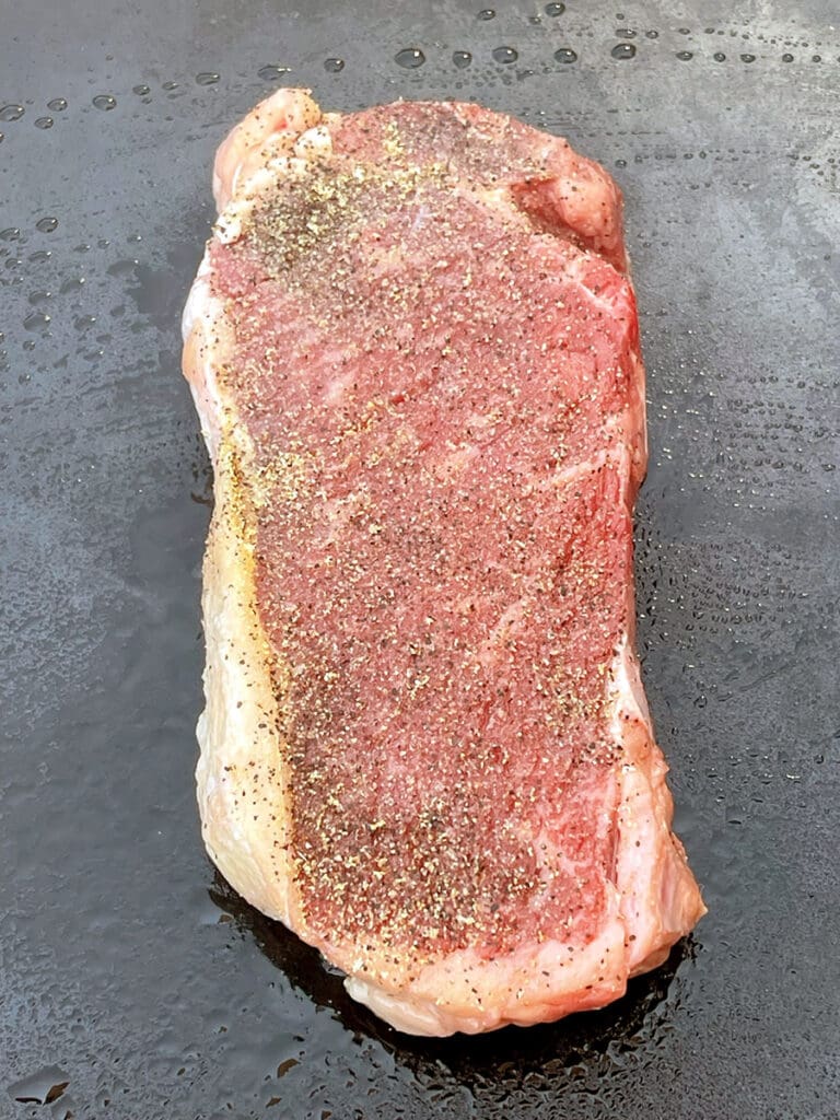 Rare steak on a blackstone.