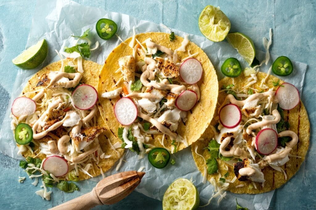 3 fish tacos on wax paper for California recipes article.
